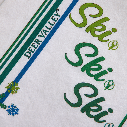 tea towel designed with snowflakes and ski ski ski
