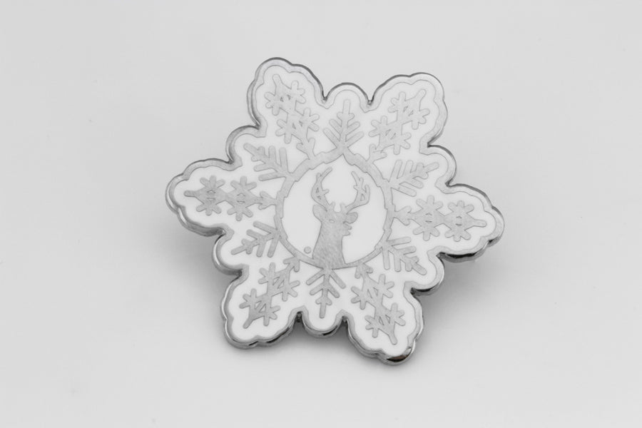 Silver and white snowflake pin
